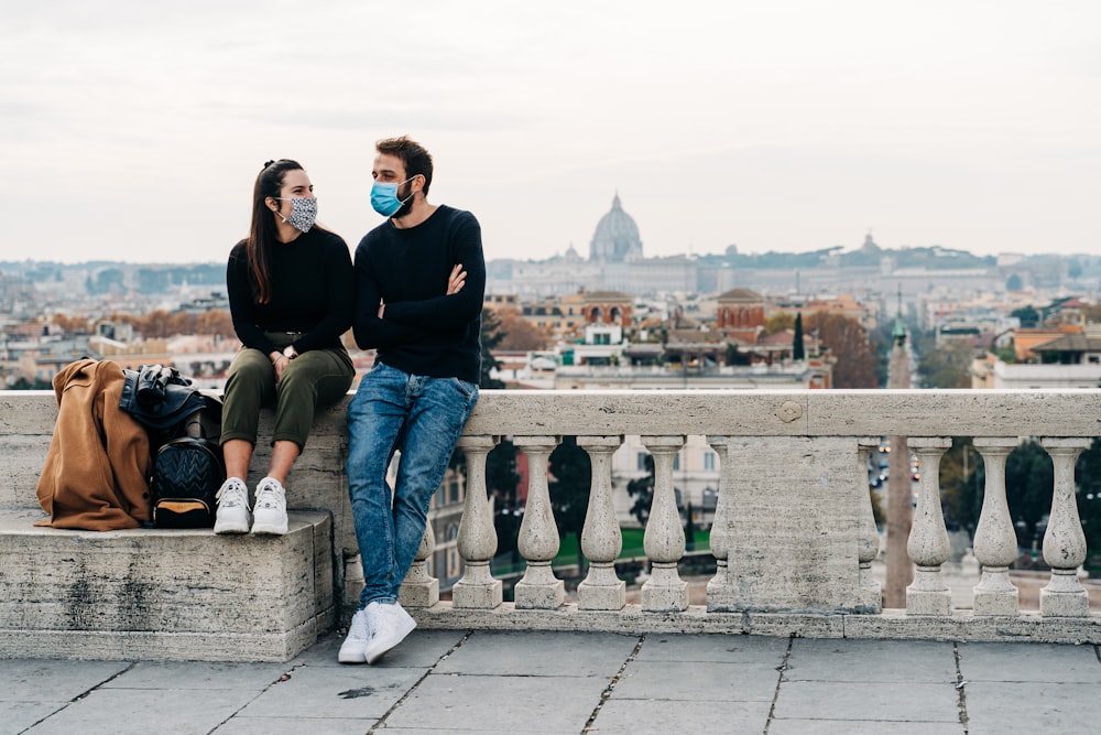 man in black long sleeve shirt sitting beside woman in black long sleeve shirt