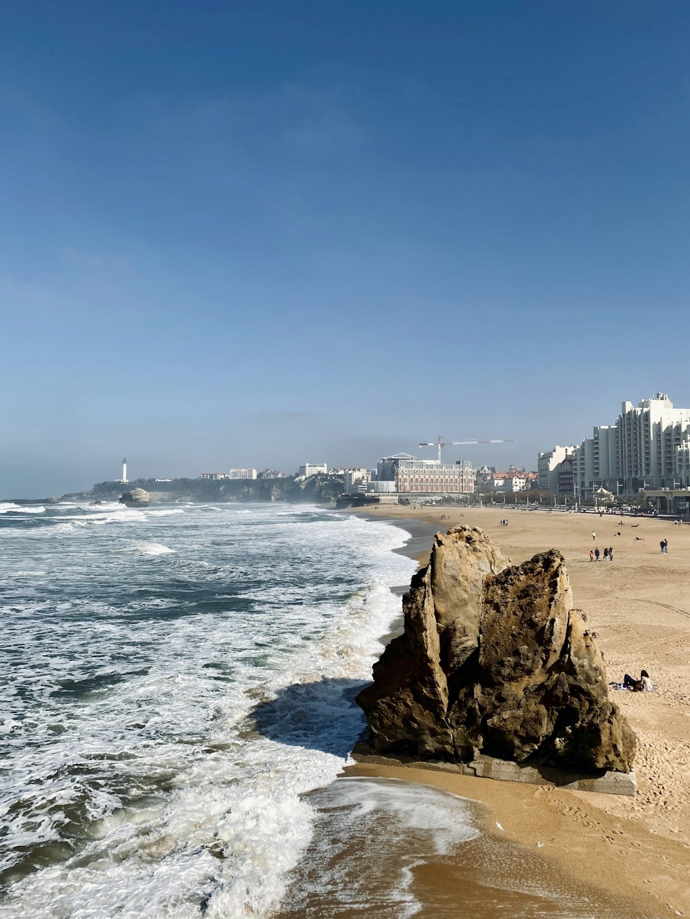 white concrete building near sea during daytime