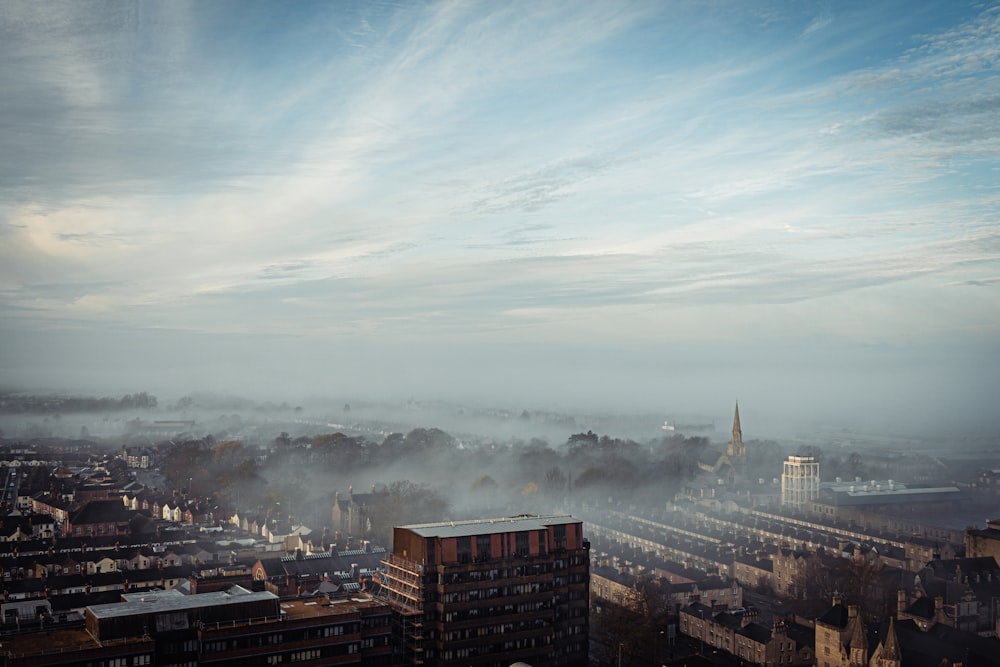 high rise buildings under white clouds during daytime