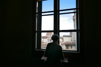 Modern Italian flat with large windows and a view of the city skyline.
