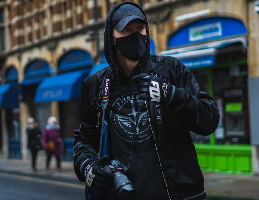 man in black jacket wearing black goggles and black helmet