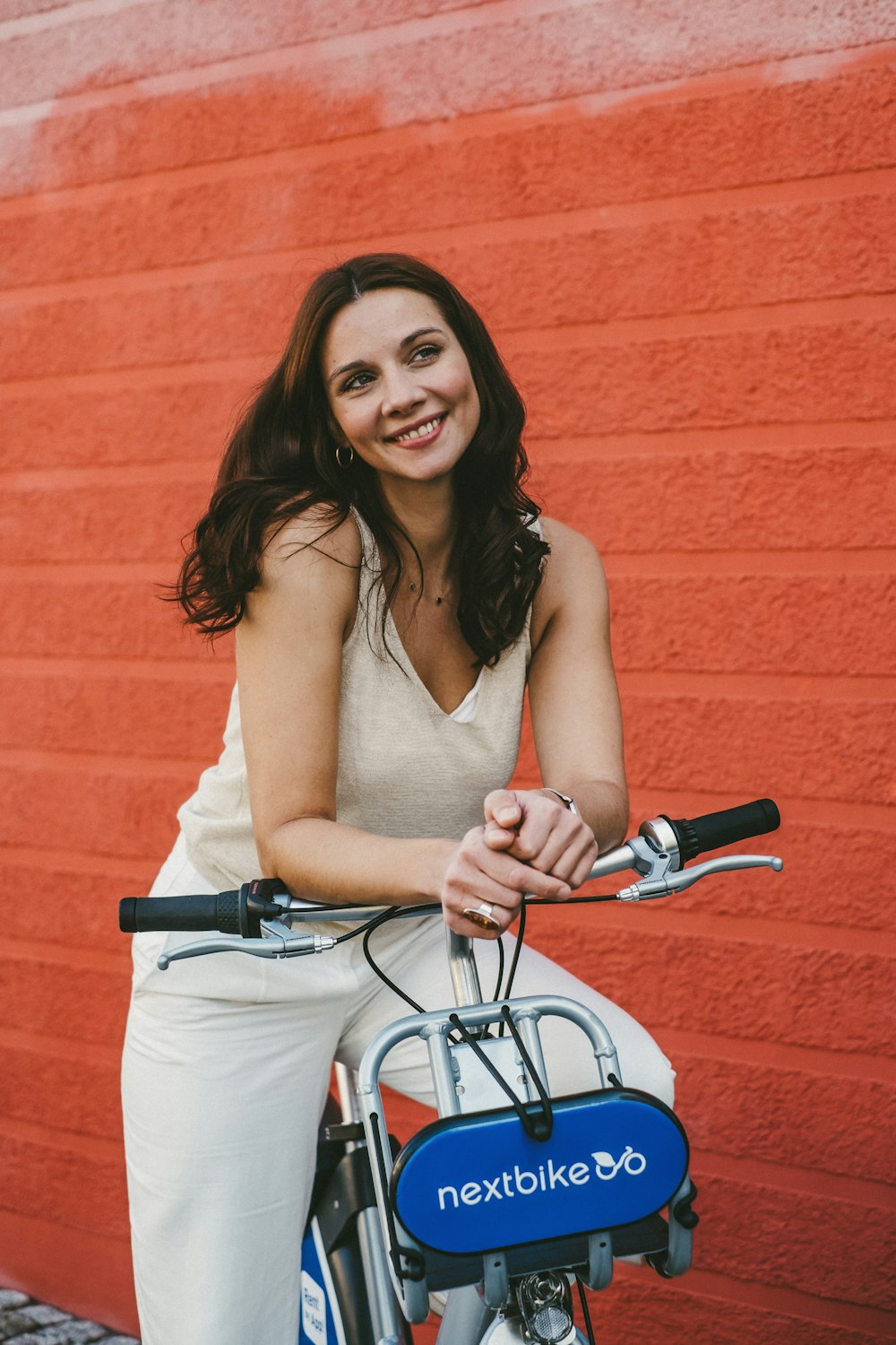woman in brown tank top riding on bicycle