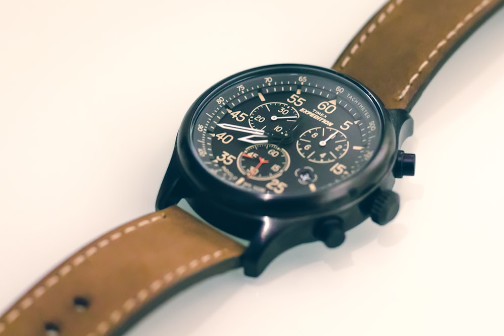 black chronograph watch with brown leather strap