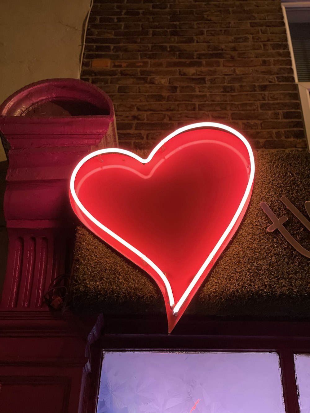 red heart shaped pillow on brown sofa