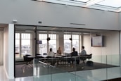 Team members collaborating in a modern conference room with city views.