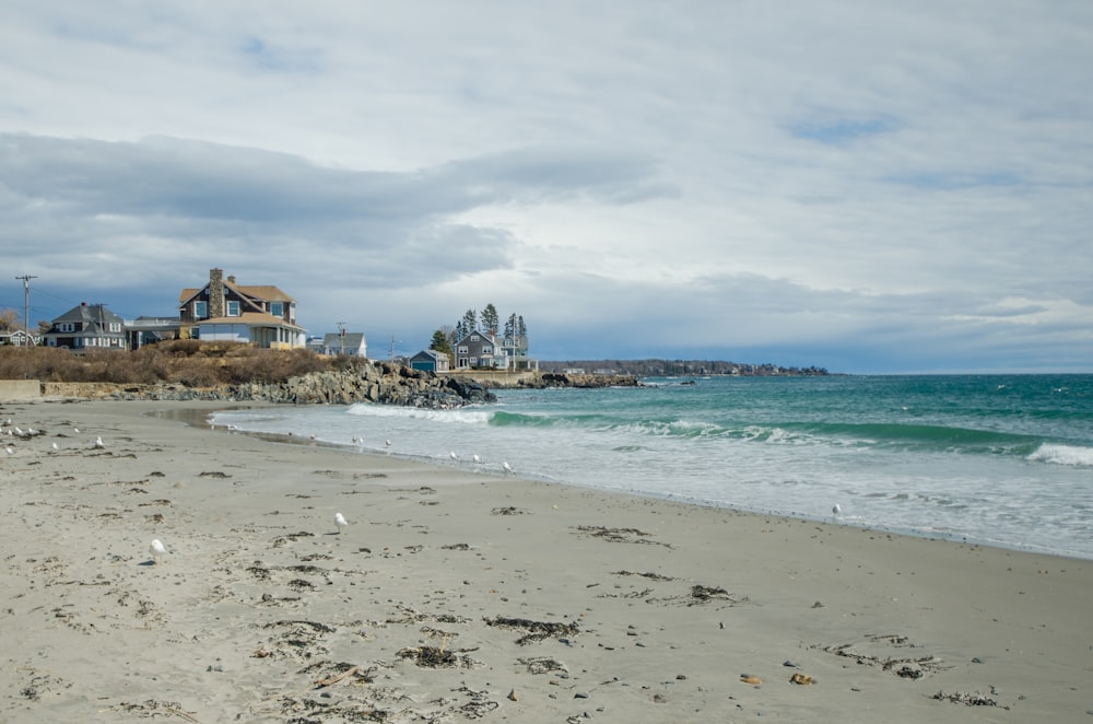 brown concrete building near sea under white clouds during daytime