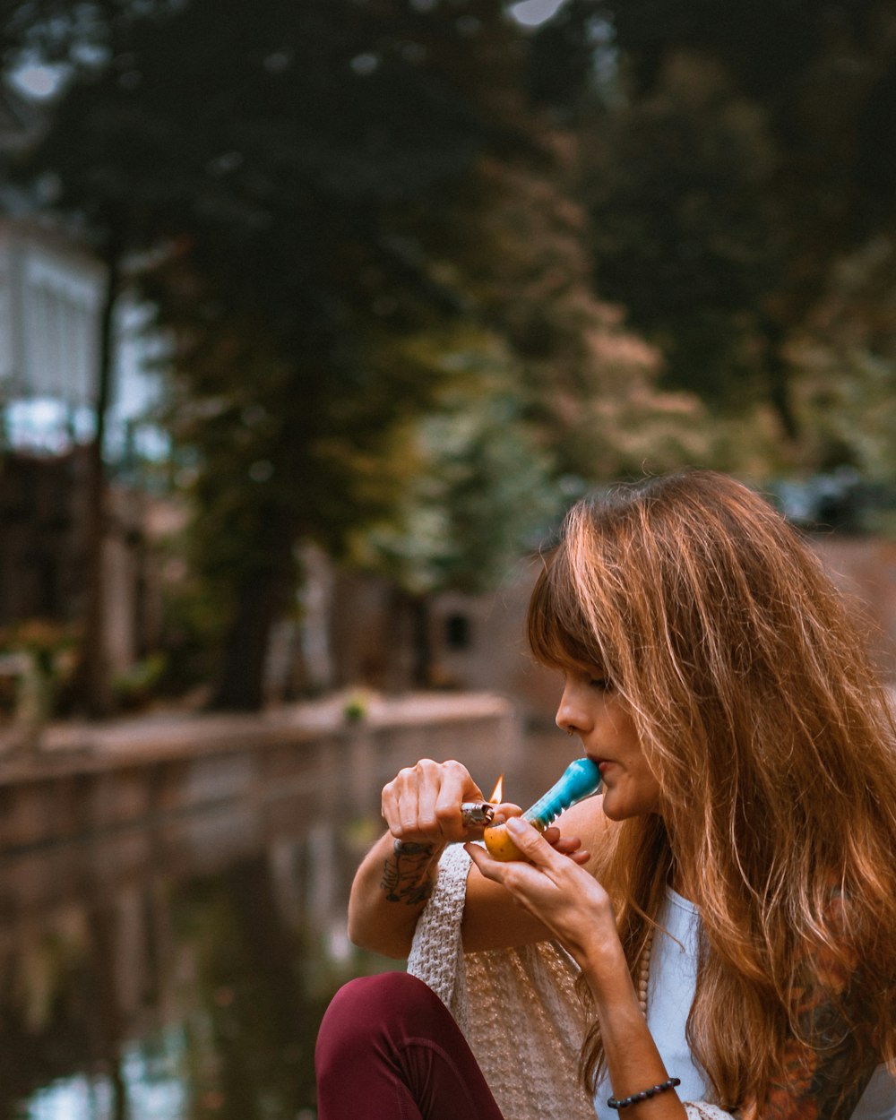 girl in pink sweater holding blue plastic toy