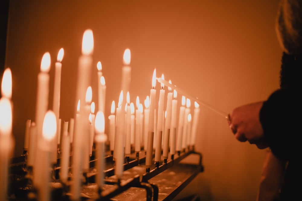 man standing near lighted candles