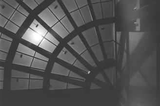 Minimalist black and white image of intersecting beams forming a precise structural pattern.