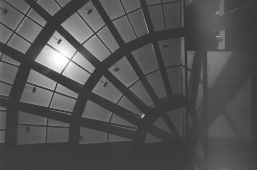 Minimalist black and white image of intersecting beams forming a precise structural pattern.