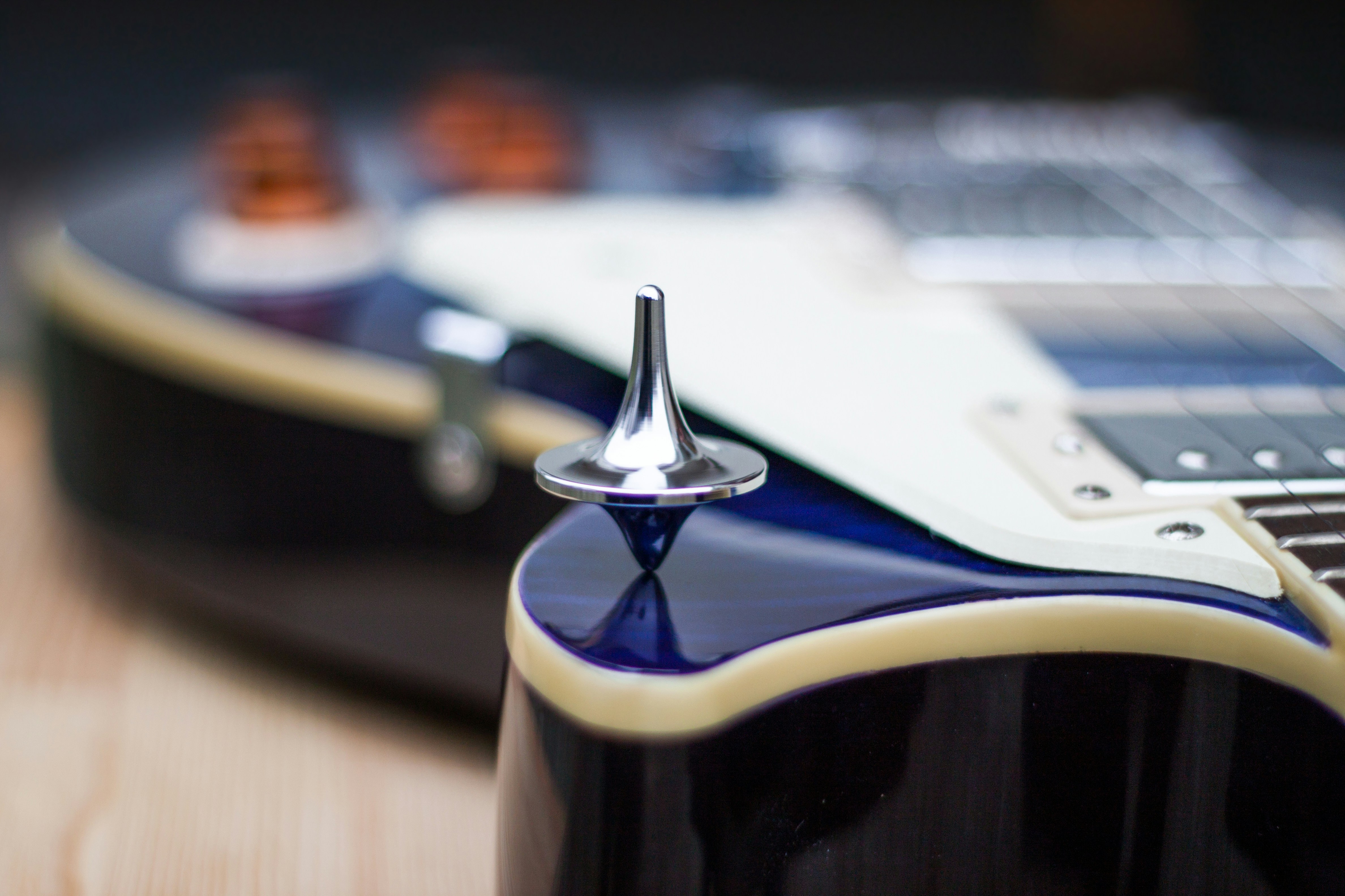 white and black ceramic mug with gold and silver spoon