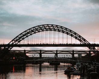 black metal bridge over river during daytime