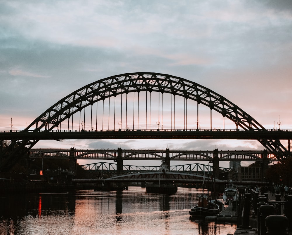 black metal bridge over river during daytime