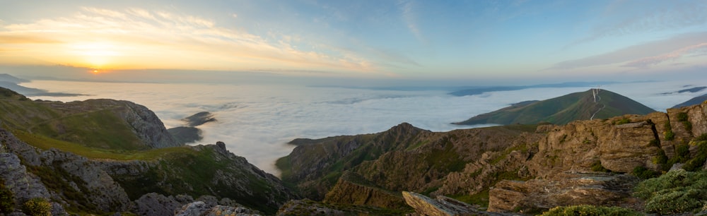 brown and green mountain beside sea during daytime