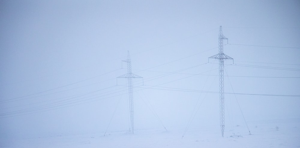 black electric post under white sky during daytime