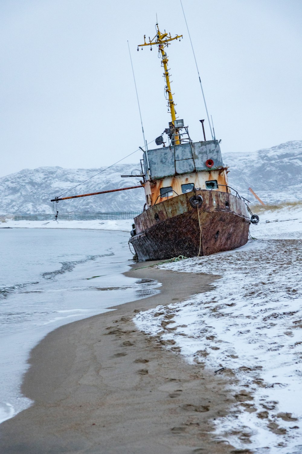 brown ship on sea shore during daytime