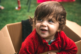 girl in red zip up hoodie smiling