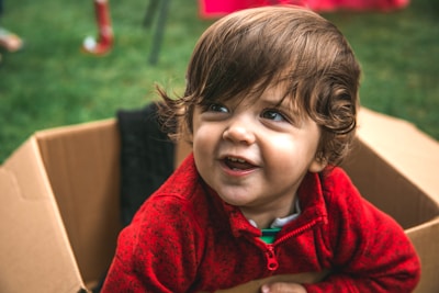 girl in red zip up hoodie smiling
