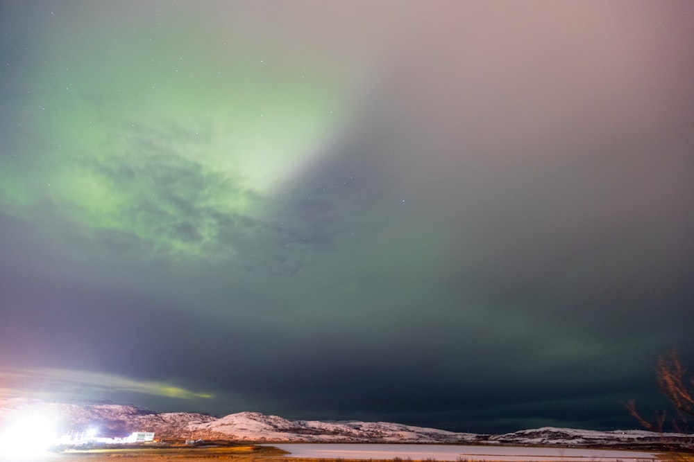 green and white sky over brown field