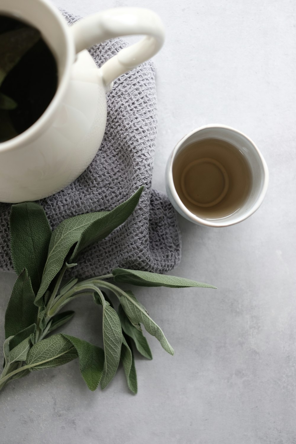 white ceramic mug with brown liquid inside