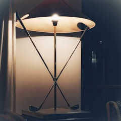 A unique floor lamp featuring a minimalist black frame.