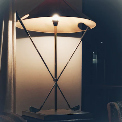 Elegant lamp casting a gentle glow over a minimalist side table.