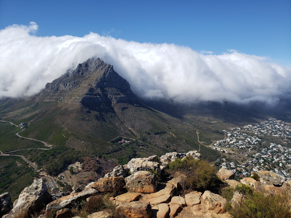 green and brown mountain under white clouds and blue sky during daytime