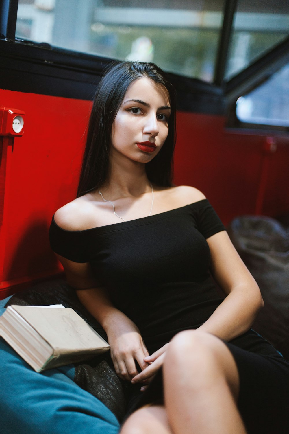 woman in black tube dress sitting on gray couch