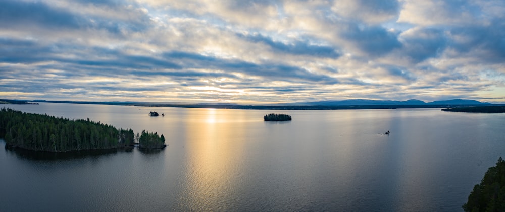 calm sea under white clouds during daytime