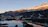 A serene sunrise over the snowy peaks of Saint Moritz, casting golden light on the frozen lake.