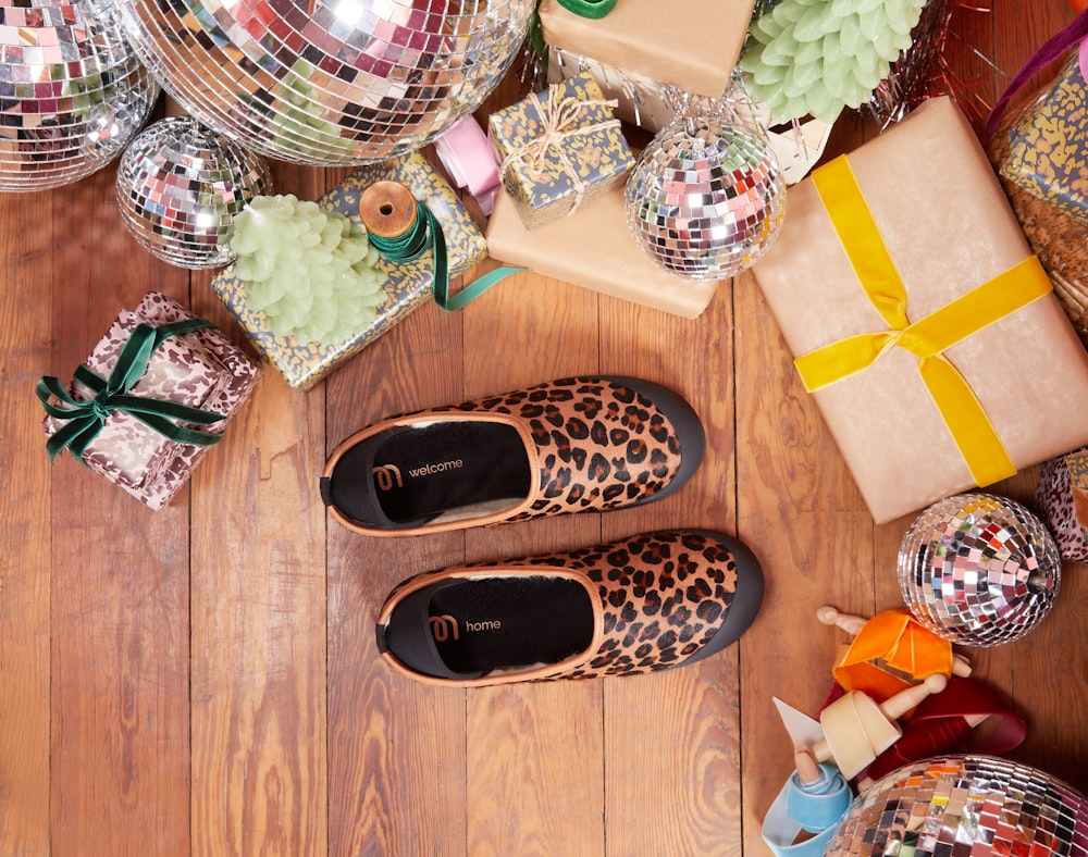 black and brown house slippers on brown wooden floor