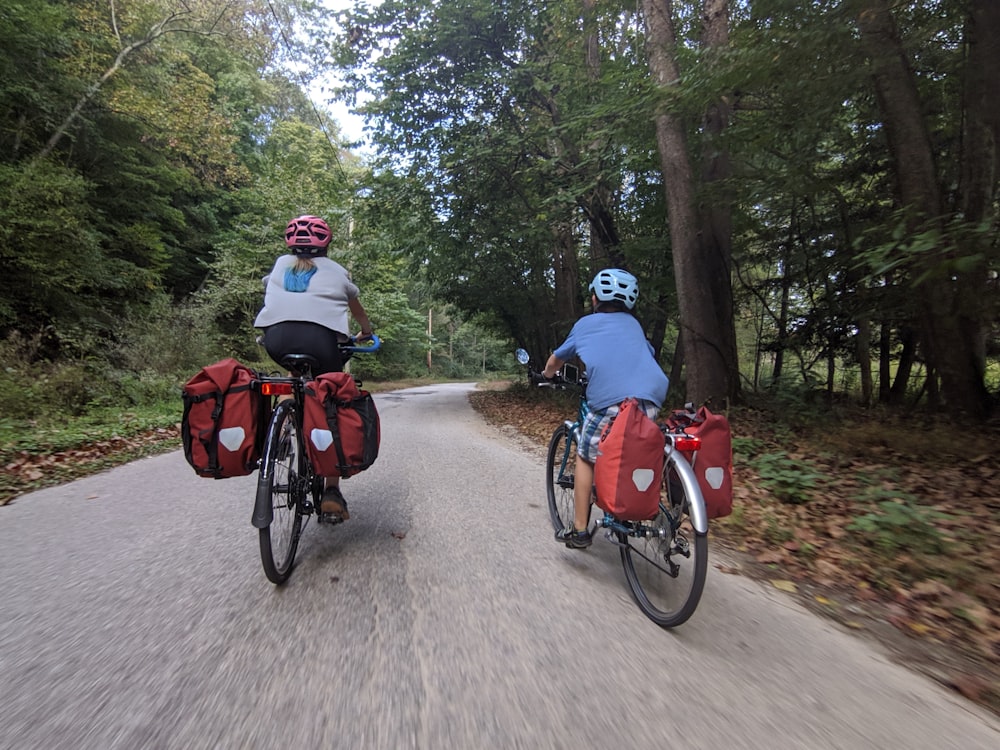 people riding bicycles on dirt road during daytime