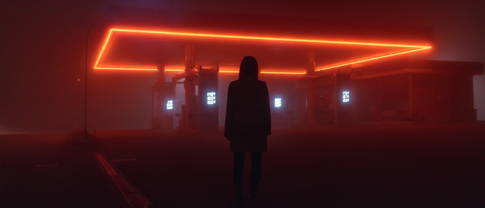 silhouette of woman standing on the field during night time