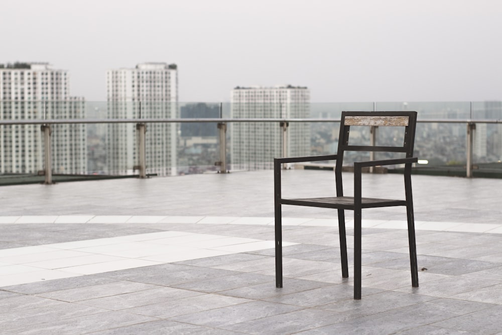 black wooden table and chairs on white floor tiles