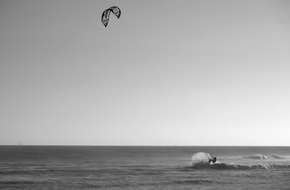 person surfing on sea waves during daytime