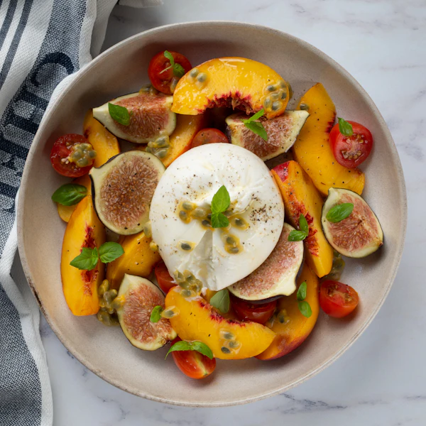 Burrata cheese plated with fresh fruit