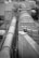 A complex industrial structure featuring large cylindrical pipes and ducts connected to various platforms and support structures. The environment suggests a manufacturing or processing plant, with metallic surfaces and geometric patterns visible.