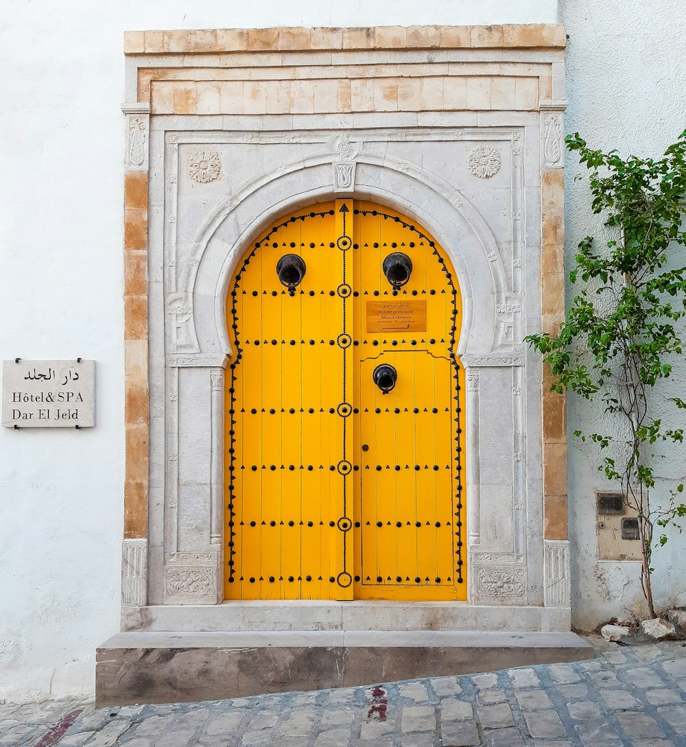 brown wooden door on white concrete building