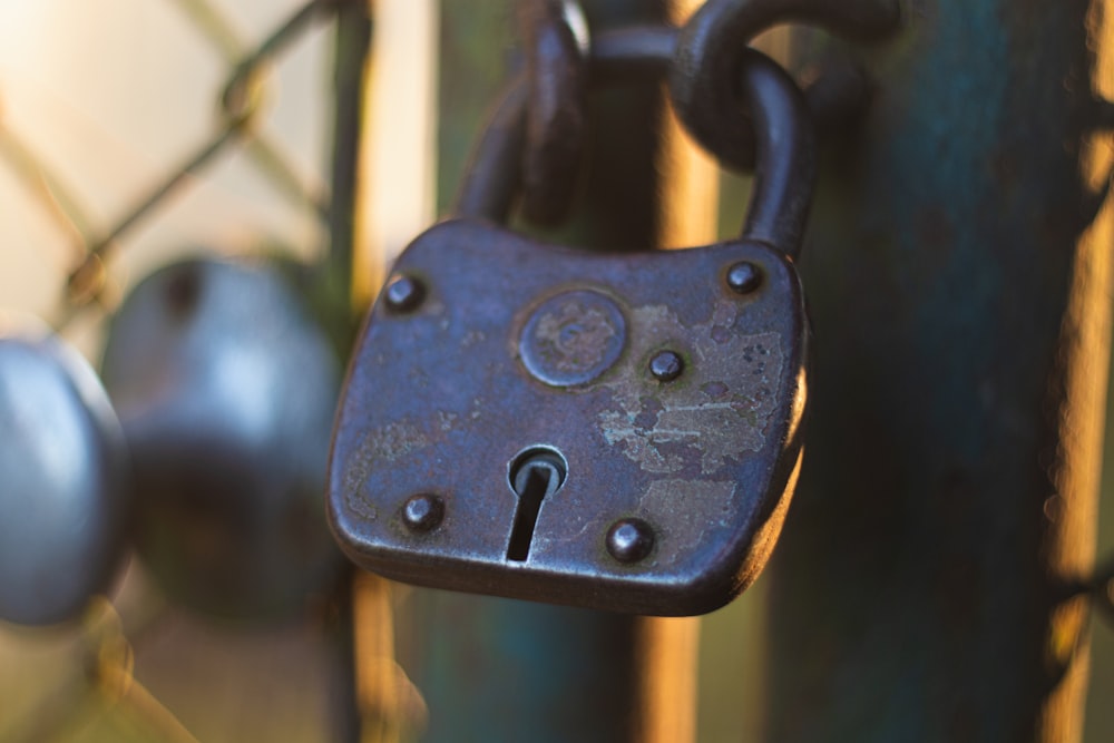 a padlock is attached to a chain link fence