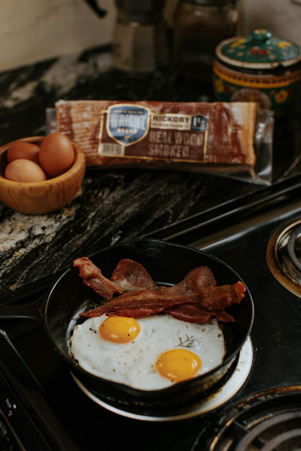 egg and sausage on black ceramic plate