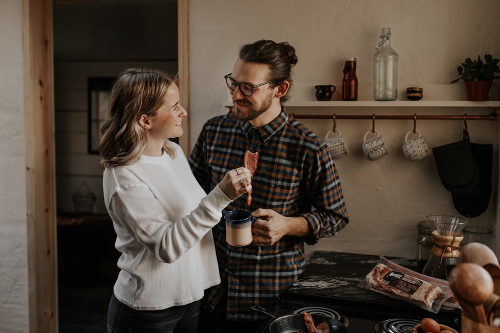 man and woman standing beside table