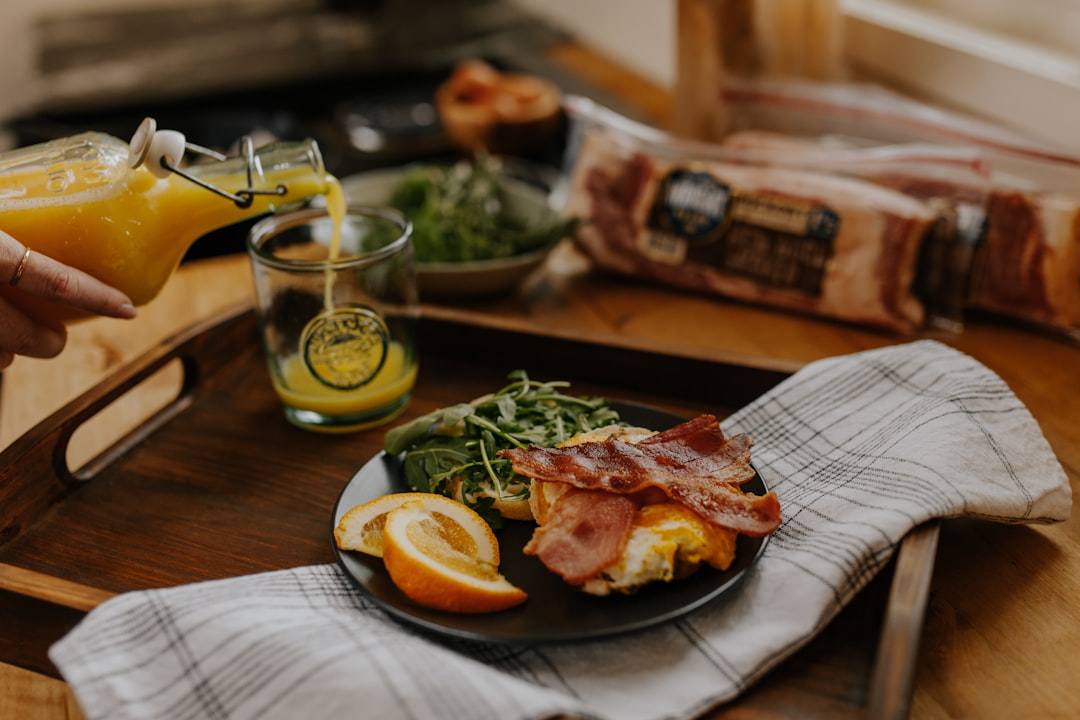 grilled meat on blue ceramic plate beside sliced lemon on brown wooden table