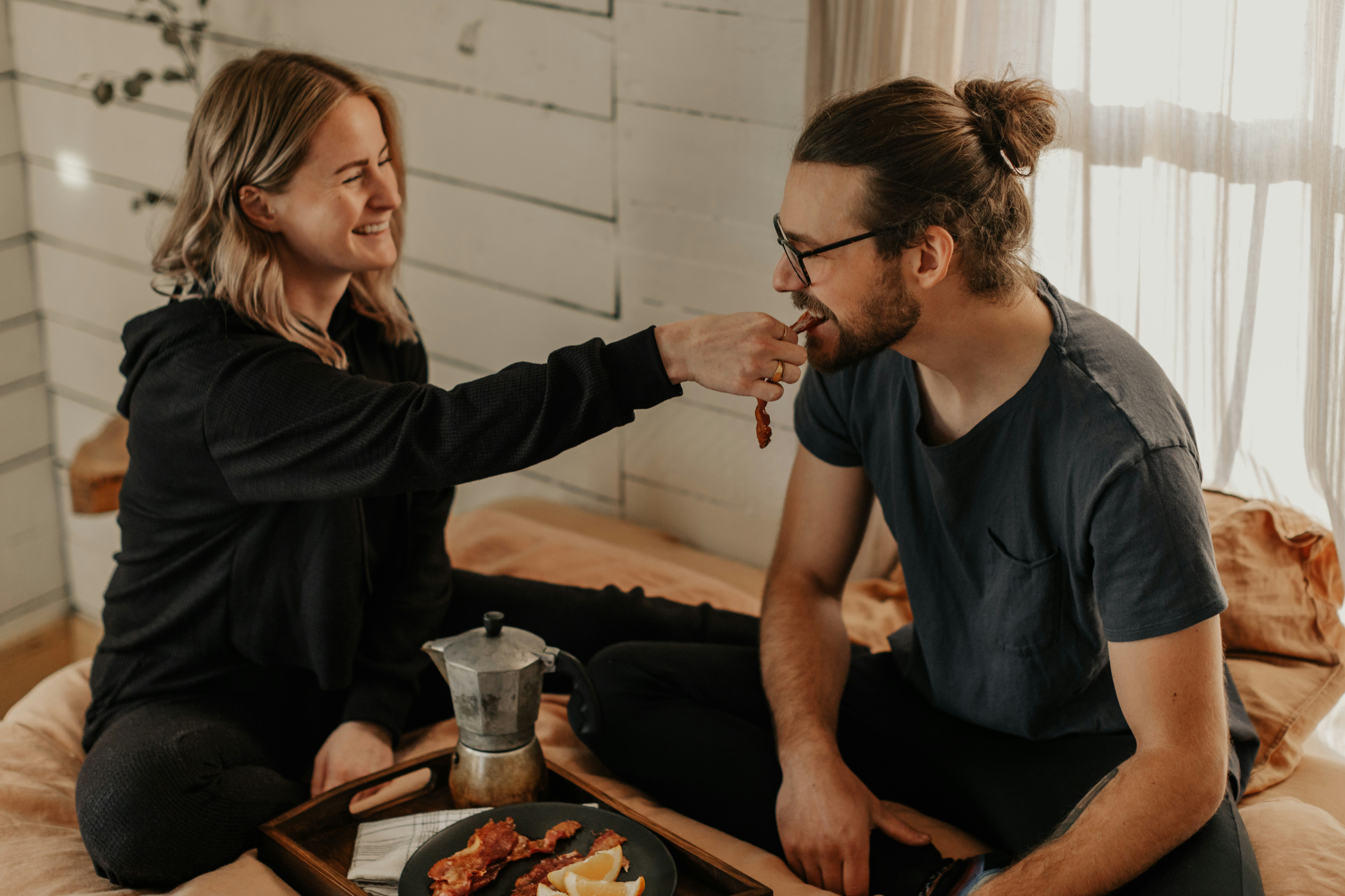 man in black crew neck t-shirt sitting beside woman in black long sleeve shirt