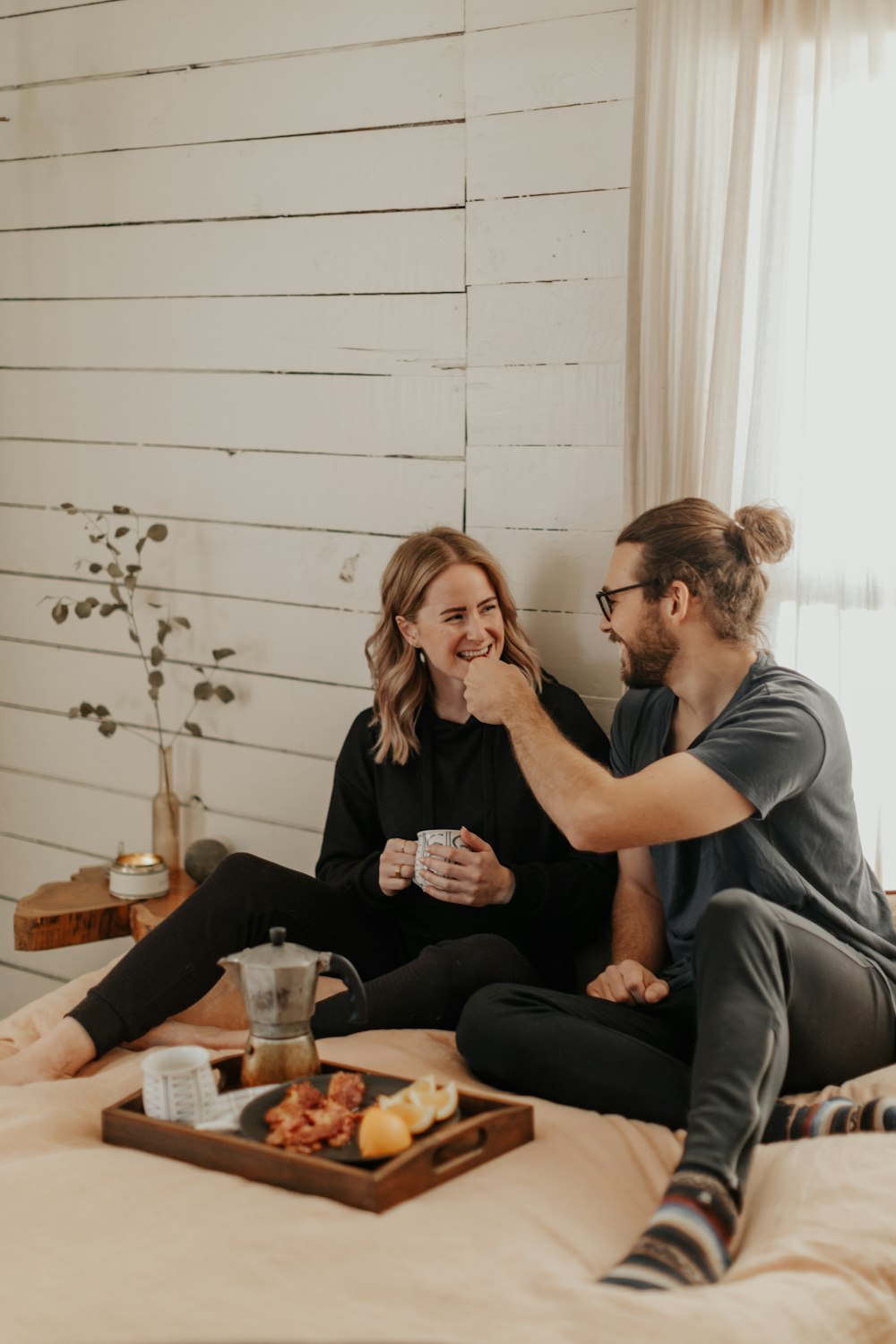 man and woman sitting on couch