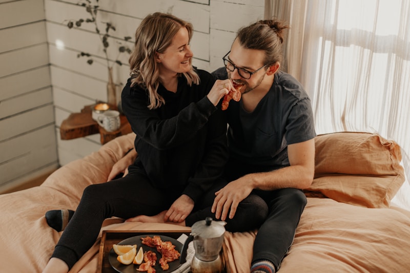 man and woman sitting on couch