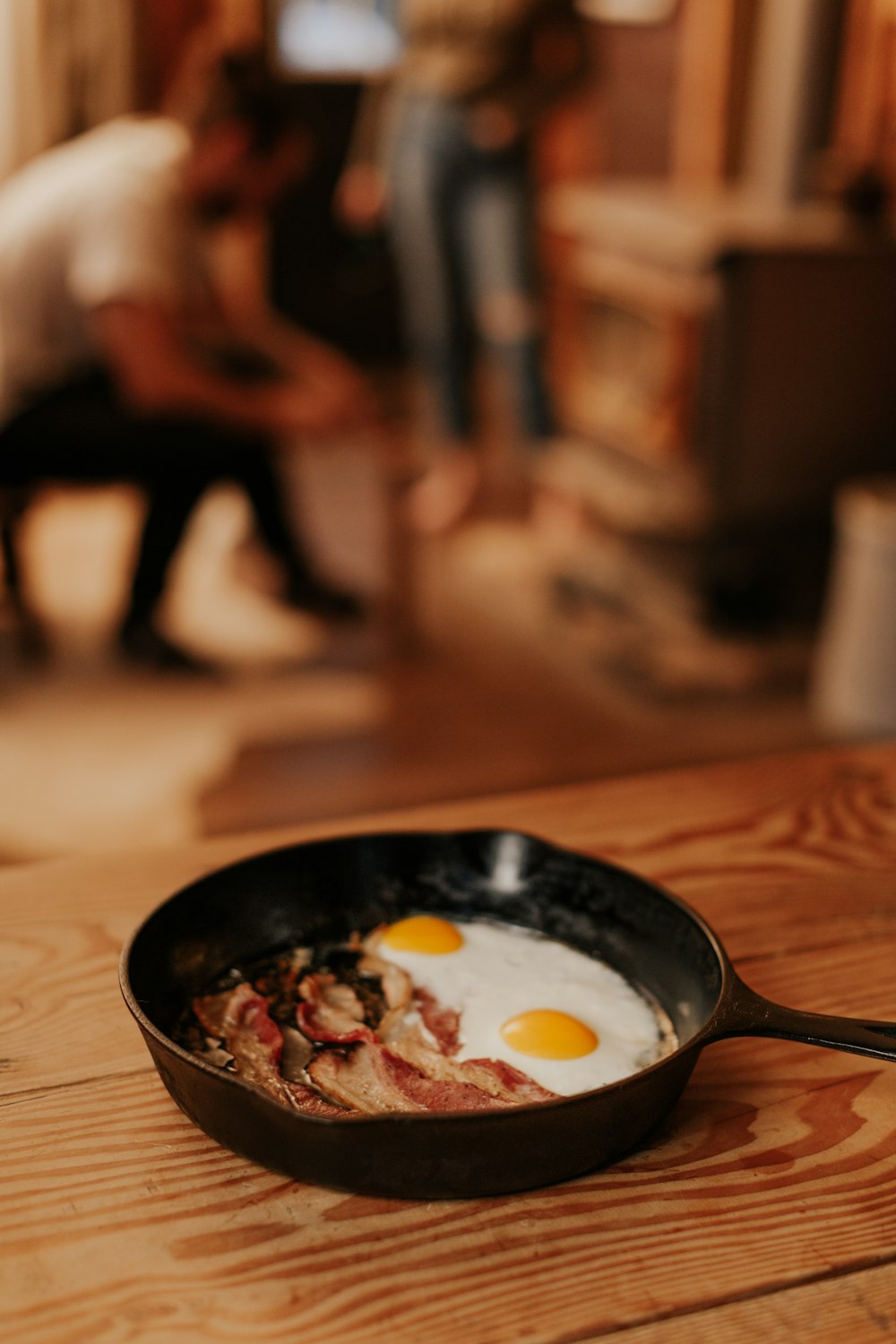 black frying pan on brown wooden table