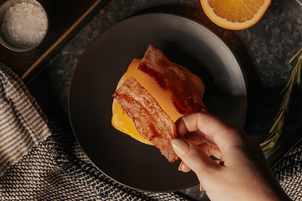 person holding a bread with sliced lemon