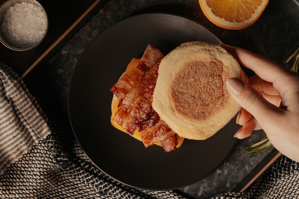 bread with egg on black round plate