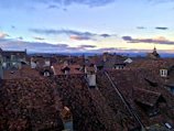 Sunset over terracotta rooftops in a quiet European village.