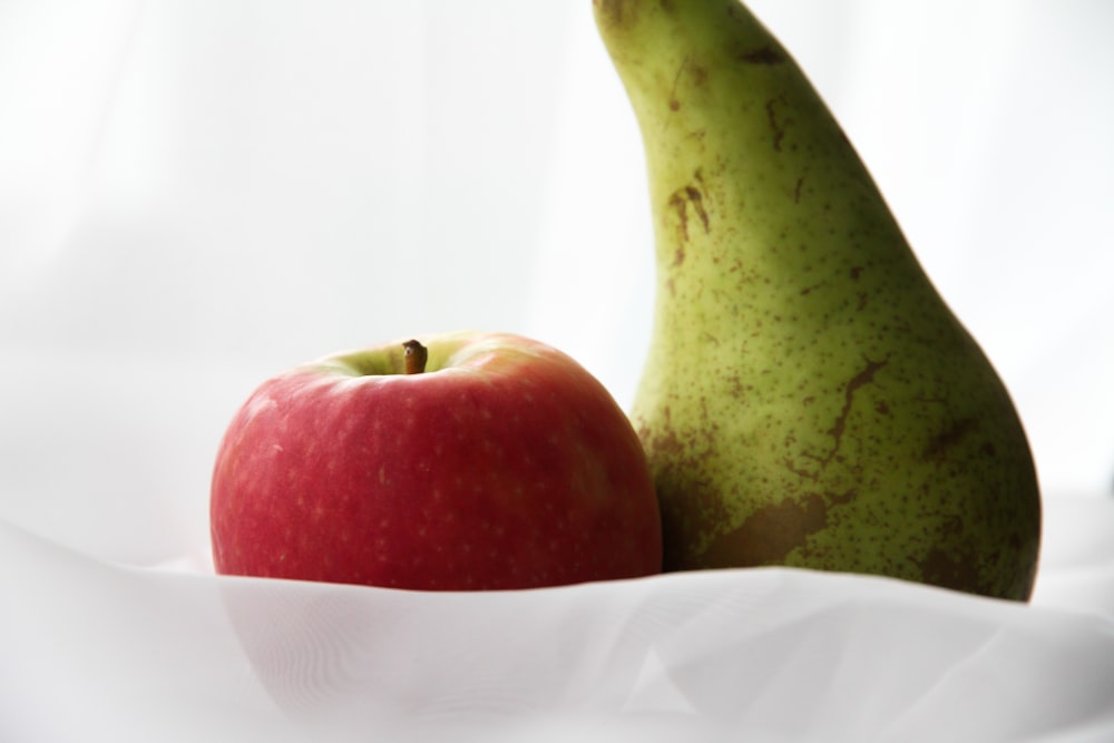 red apple fruit on white paper